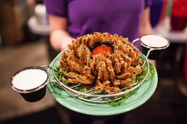 blooming onion being held by one of the waiters