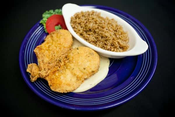 fried steak with sauce with a side of rice