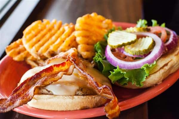 sweddar with bacon, pickles, lettuce, onions and a side of fries