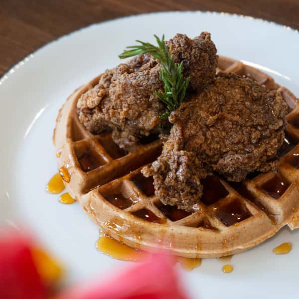 Chicken and waffles with rosemary sprig