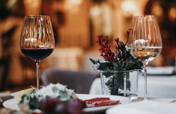 Wine on a table with dinner served