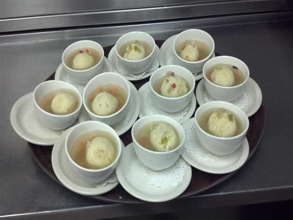 small cups of soup with matzoh balls