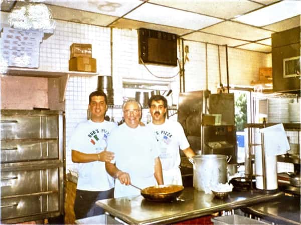 Three men in kitchen