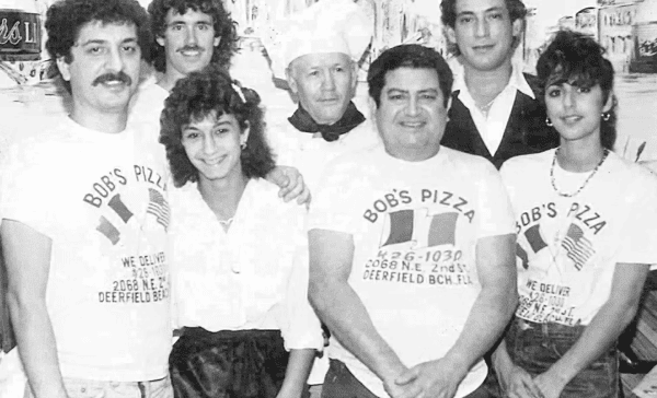 Vintage group photo of the Bob's Pizza team in Deerfield Beach, Florida, featuring staff in branded T-shirts and a chef in uniform