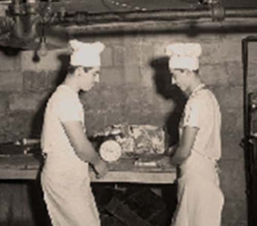 Historic black-and-white photo of Gorat's Steak House staff preparing food, celebrating the restaurant's long-standing Omaha tradition.