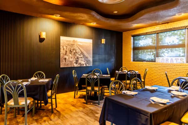 Warm dining room with classic tables and historic decor at Gorat's Steak House in Omaha