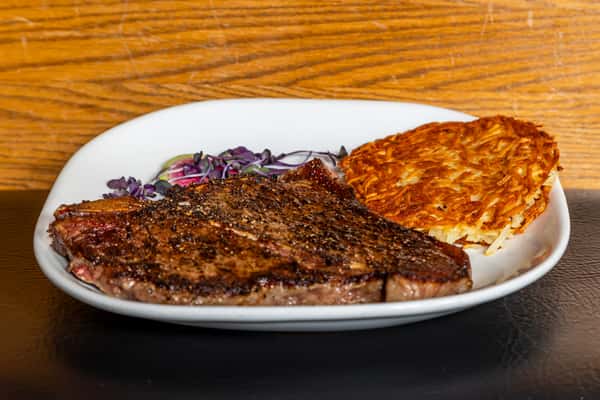 Grilled porterhouse steak with crispy golden hash browns at Gorat's Steak House in Omaha
