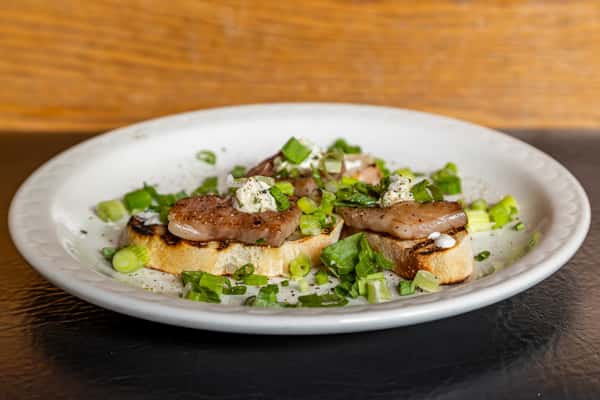 A5 Wagyu crostini appetizer with tender beef and fresh herb garnish at Gorat's Steak House