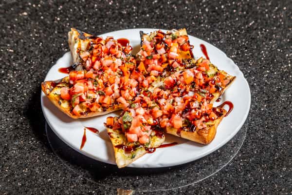 Bruschetta topped with diced tomatoes, herbs, cheese, and balsamic glaze at Gorat's Steak House
