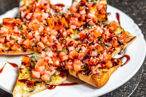 Bruschetta topped with diced tomatoes, herbs, cheese, and balsamic glaze at Gorat's Steak House