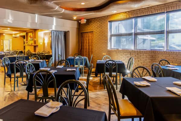 Warm traditional dining room with tables and chairs at Gorat's Steak House in Omaha