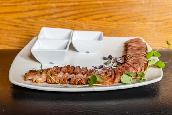 Sliced 12-ounce A5 Wagyu beef with seasonings and accompaniments at Gorat's Steak House
