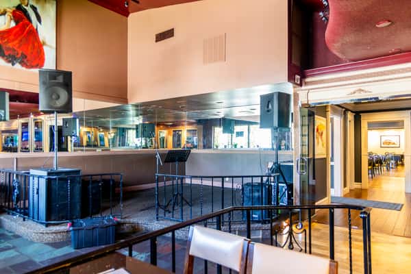 Classic bar and dining area with colorful lighting inside Gorat's Steak House in Omaha