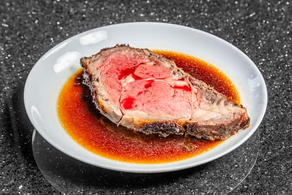 Black and bleu prime rib topped with melted cheese, served with mashed potatoes and au jus