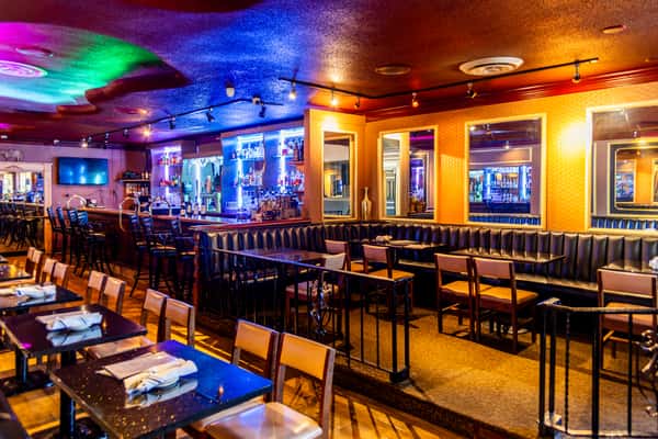 Classic bar and dining area with colorful lighting inside Gorat's Steak House in Omaha