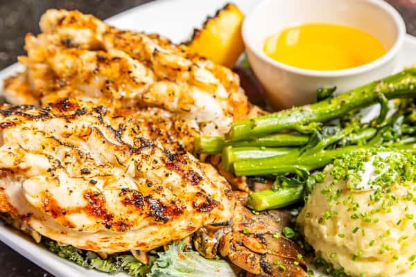 Lobster dinner with Yukon potatoes, broccolini, grilled lemon, and drawn butter at Gorat's Steak House
