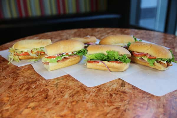assortment of signature sandwiches on refurbished particle board table