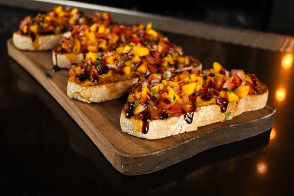 Seasonal: Mango jam, roasted pineapple, mango, sweet pepper, red onion, dash of cilantro with a balsamic glaze