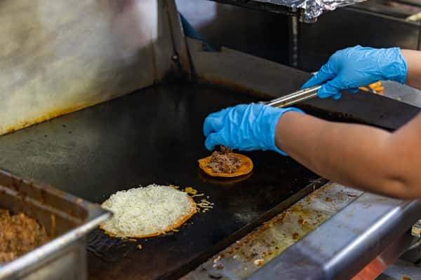 Person preparing a taco