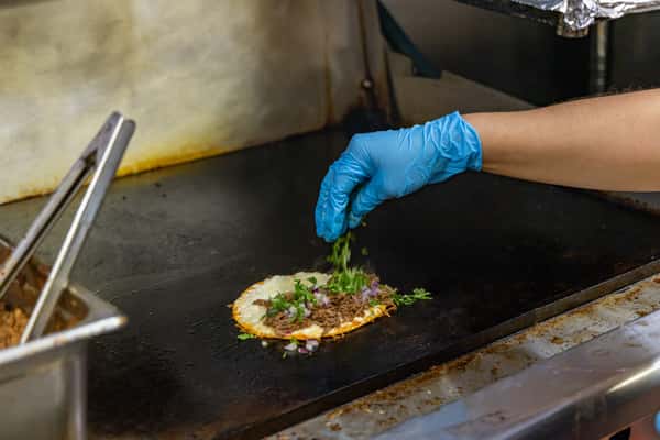 Person preparing a taco