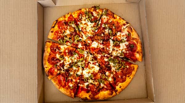 Pepperoni pizza with green olives and sausage in a cardboard box.