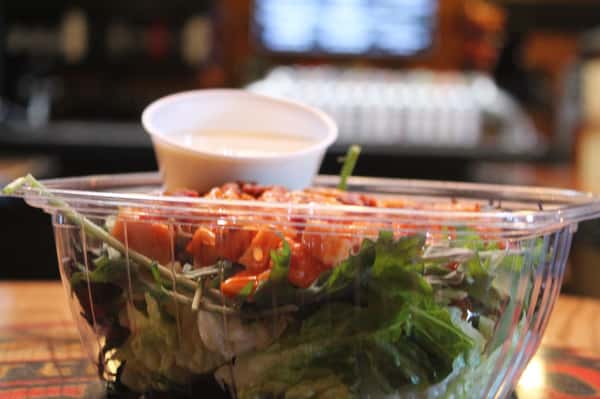 Side profile of salad in a plastic container