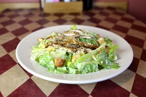 a caesar salad with grilled chicken