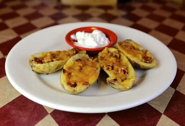 loaded potato skins with a side of dip