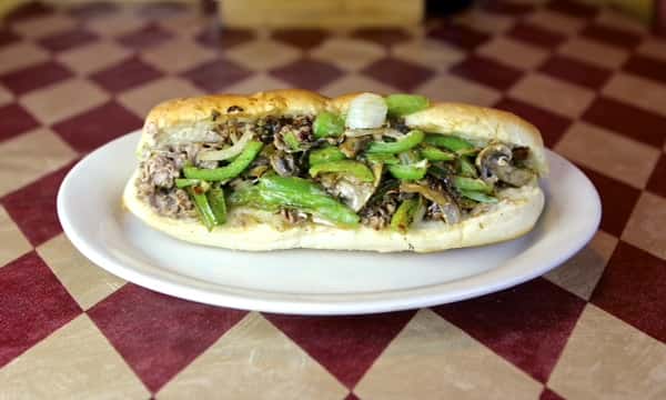 a sub with steak, green peppers and onions
