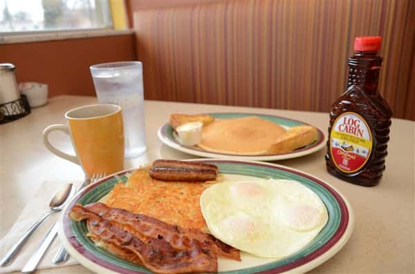 pancakes, eggs and sausage with syrup