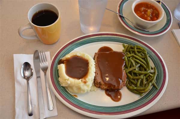 meatloaf with gravy, mashed potatoes and gravy abd stering beans