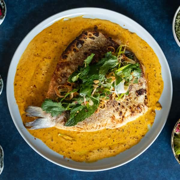 butterflied branzino over sauce