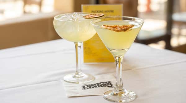 Two citrus cocktails with garnish