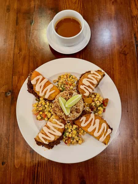 Bison Birria Tacos
Slow cooked with chiles & spices stuffed in corn tortilla shells w/ cheese then pan fried served w/ garlicky pinto beans & rice, street corn salsa, chipotle crema & a smokey broth for dipping