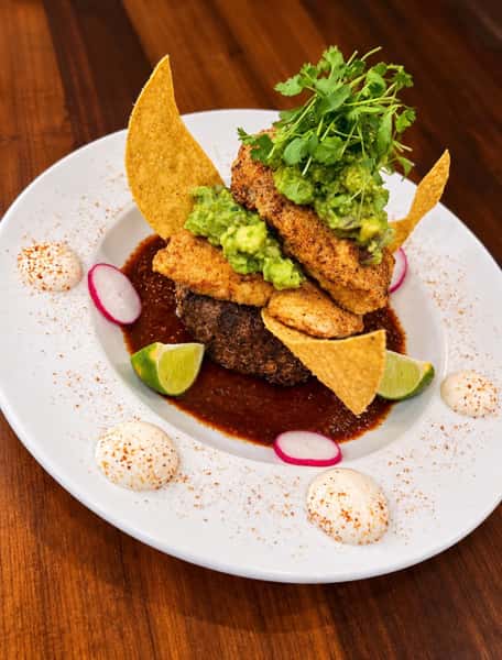 Red Emperor Fish In Ancho Sauce

Pan fried w/ tajin & spices served over black bean & roasted corn cake w/ made to order guacamole & chipotle crema