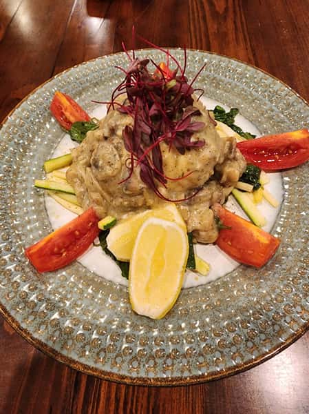 Stuffed Flounder (Alaskan)
w/ rustic sourdough wild rice stuffing served over a bed of roasted vegetables (Zucchini, Roma Tomato & Kale) w/ Dijon & dill exotic mushroom sauce