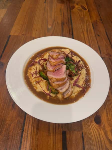 Pan Seared Duck Breast (Medium Rare)
Served over roasted apple & parsnip puree w/ bourbon/maple & bacon brussels sprouts & peppered red wine demiglace