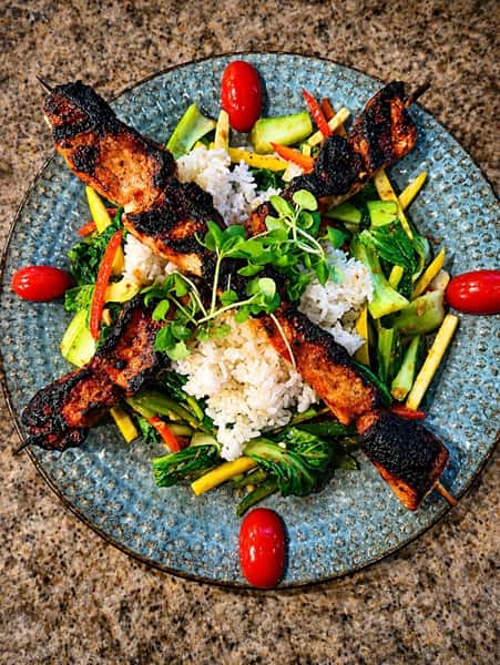 Sticky Pork Loin Skewers
Marinated & grilled served over stir-fried bok choy w/ garlicky peanut sauce & steamed basmati rice finished w/ sweet & spicy ginger glaze