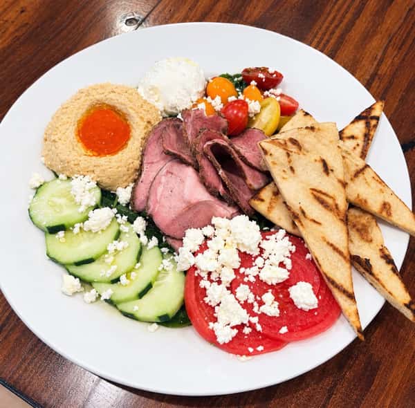 Smoked Lamb Gyro Bowl (Cooked To Medium)
Cucumber, tomato, pickled red onion, homemade red pepper hummus, feta & tzatziki served over baby spinach dressed w/ oil & vinegar served w/ grilled pita