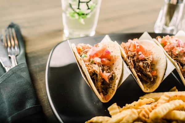 Tacos served with crinkle-cut fries and a drink