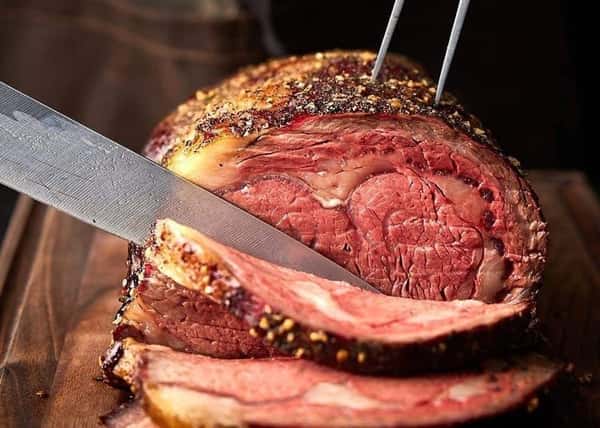 Seasoned meat being thinly sliced