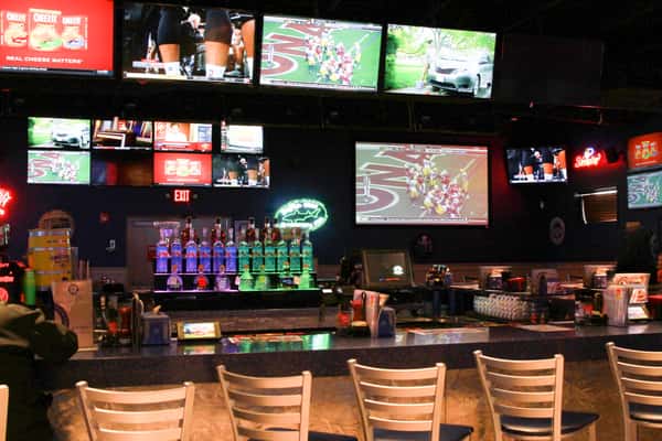 Bar with full stocked liquor shelves and large screen TV's for sports