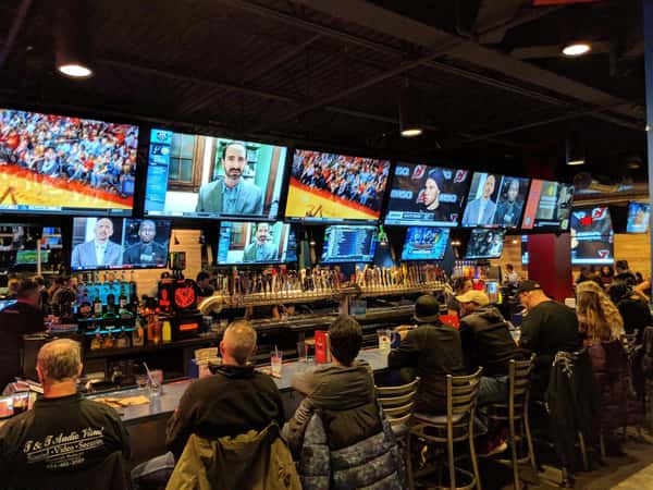 Crowded sports bar with large screen TV's in East Brunswick at Arooga's