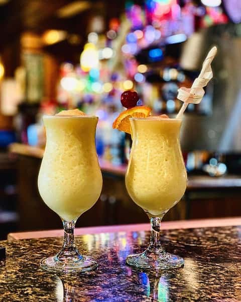 two thick drinks in martini glasses