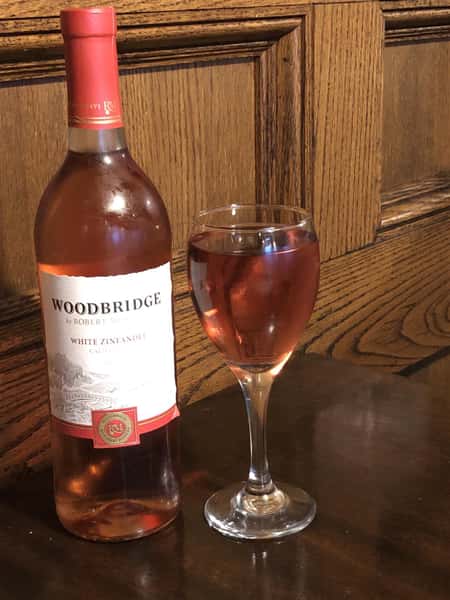 a bottle of Woodbridge wine, next to a glass of wine