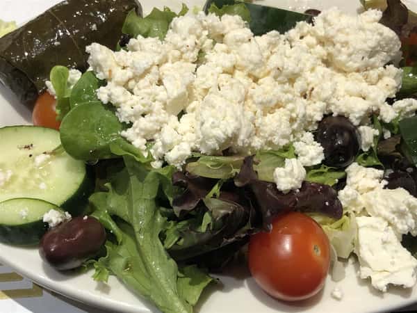 a Greek salad with olives, cucumbers, cherry tomatoes and feta cheese