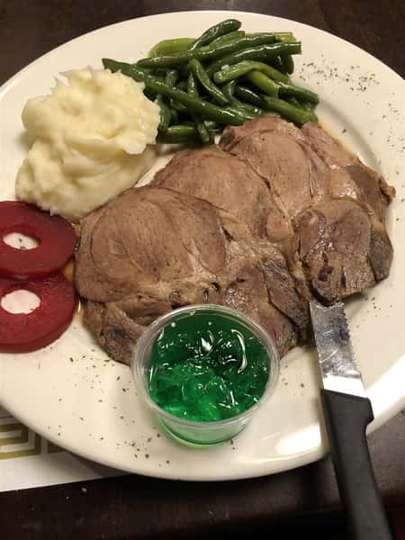 Roast Leg of Lamb with side of mashed potatoes and green beans