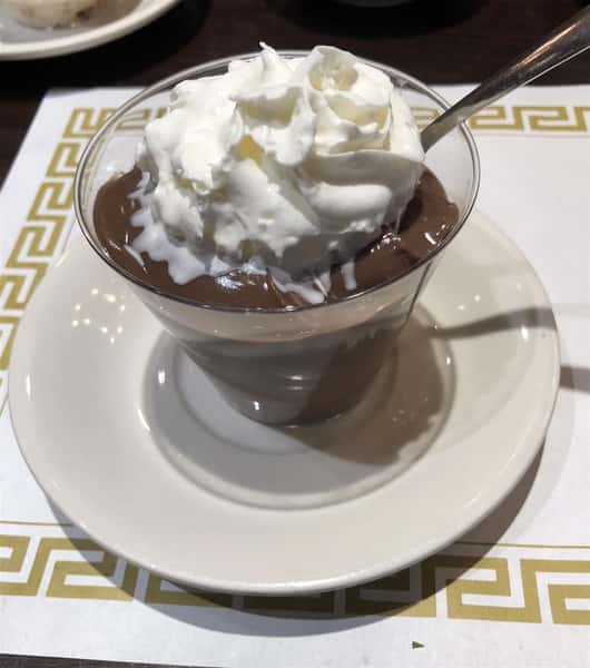 a cup of chocolate pudding, with whipped cream on top