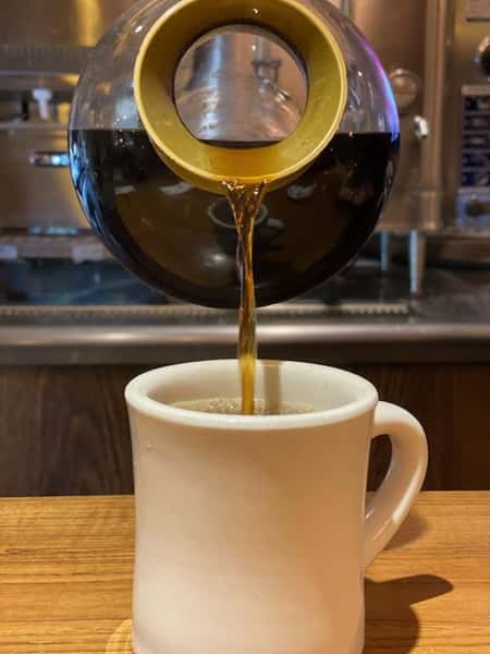 coffee being pured into a mug