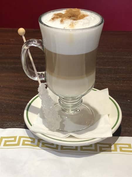 cappuccino with a sugar stick on the side